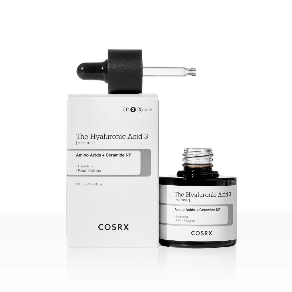 A bottle and box of COSRX The Hyaluronic Acid 3 serum, showcasing a black bottle with a dropper, labeled with product details emphasizing hydration and moisture retention.